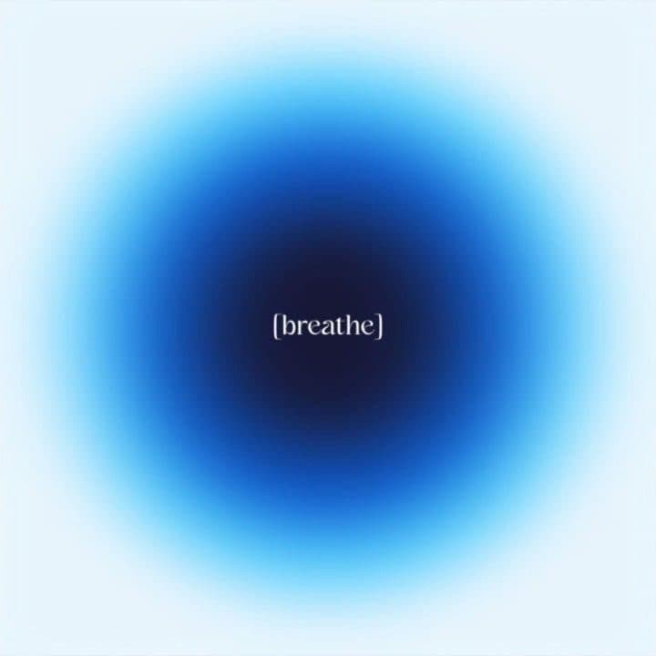A softly glowing circle with the word breathe at its centre