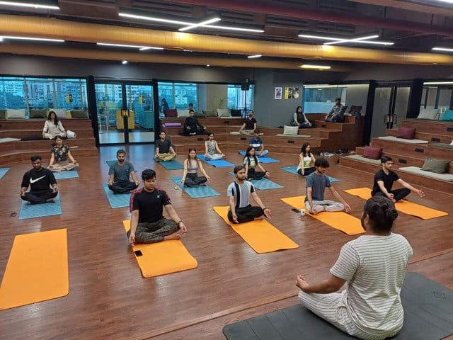A large group class practising together in a hall