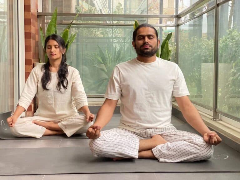 Yogacharya Manish and Yogini Pooja seated in meditation