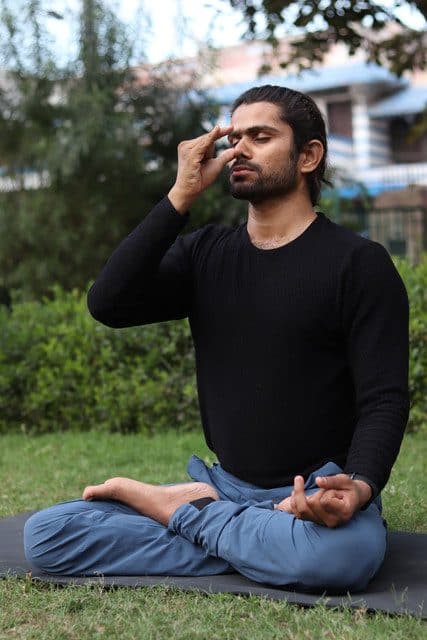 Yogacharya Manish practising pranayama outdoors